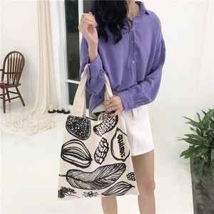 Minimalist leaf print large canvas tote bag for women showing daily commuting style