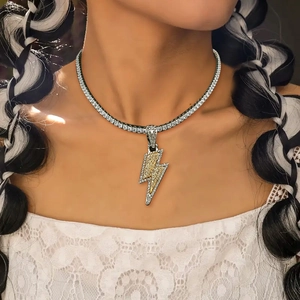 Close-up of hip-hop lightning bolt pendant with sparkling crystals on a tennis chain