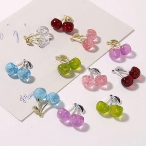 Detailed view of colorful glitter resin cherry charms for DIY jewelry making