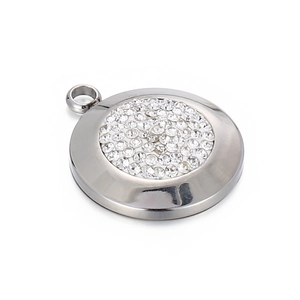 Polished stainless steel circular pendant with sparkling crystal center on white background
