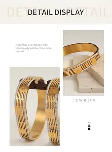 Detail view of gold hollow chain bracelet featuring micro-pave crystals and brushed finish