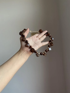 Detail of vintage acrylic leopard print square beads and brown wooden spheres on a necklace