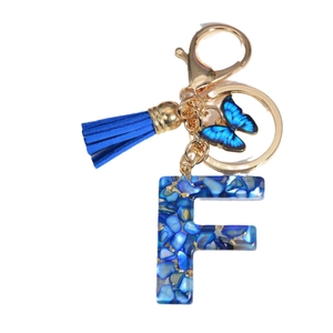 Royal blue resin letter F keychain with butterfly charm and tassel on gold ring