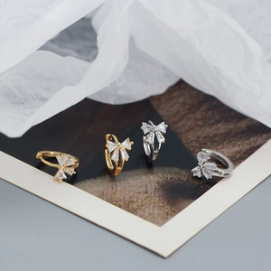 Elegant bow-shaped earrings with sparkling cubic zirconia in gold and silver finishes