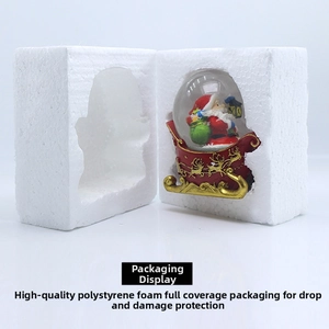 Christmas snow globe with Santa in a sleigh inside protective foam packaging box