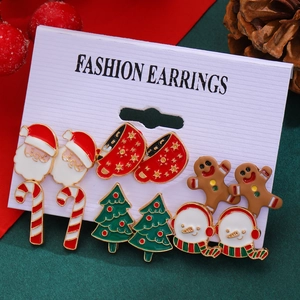 Detailed view of Christmas stud earrings set with Santa, reindeer, and gingerbread designs