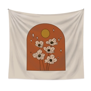 Detail of bohemian wall tapestry showing floral and sun patterns in caramel colors