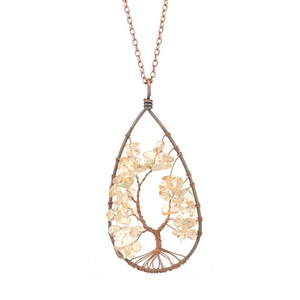 Close-up of tree of life pendant with copper wire wrap and natural stones on white backdrop