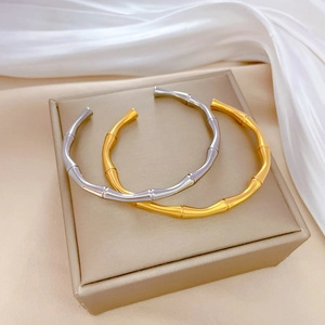 Bamboo style titanium steel open bracelets in gold and silver finish on silk