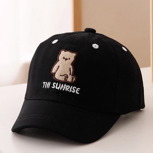 Close-up of cute bear embroidery and white letter stitching on a black cotton baseball cap