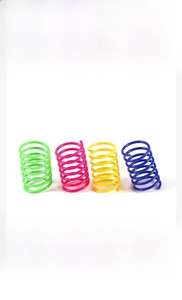 Close-up of four-color plastic spring cat toys including green pink yellow and blue spirals