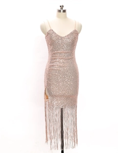 Detail of rose gold sequin dress featuring deep V-neckline and elegant fringe hemline