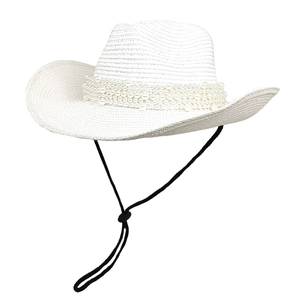 Detailed close-up of a white straw cowboy hat featuring multi-layer pearl bead decorations