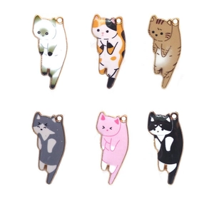 Close-up of six colorful enamel cat charms for DIY jewelry making in various patterns
