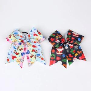 Detail of two large Christmas grosgrain hair bows featuring snowman and reindeer patterns