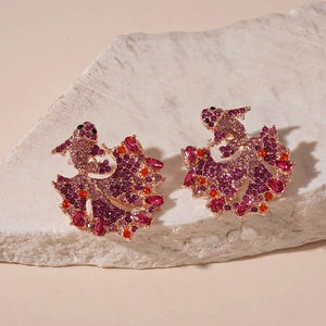 Exquisite koi fish earrings with colorful crystals on elegant stone display background