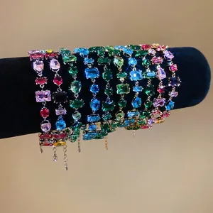 Colorful geometric zircon bracelets with mixed multi-color stones on black velvet display
