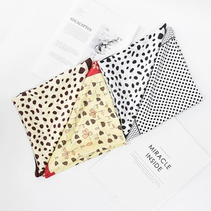 Silk-feel small square scarves with polka dots and floral patterns on magazines