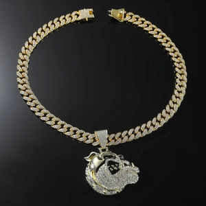 Macro shot of gold-plated Cuban chain necklace featuring a bulldog pendant with clear crystals