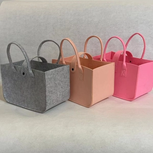 Detailed view of thick felt storage bags in grey and pink with reinforced handles