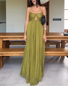 Detail of olive green maxi dress with pleated skirt and cutout bodice on a model