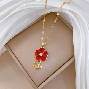 Elegant gold necklace featuring a luxury red flower pendant with crystals on silk