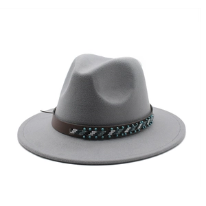 Detail of grey wool fedora hat with bohemian beaded leather band and wide brim