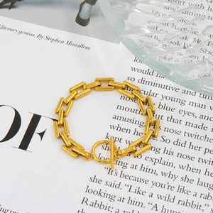 Golden stainless steel rectangle link bracelet with OT toggle clasp on a vintage book