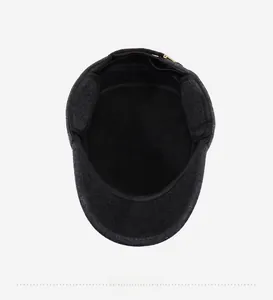 Detail of dark grey winter hat featuring thick velvet lining and foldable ear flaps