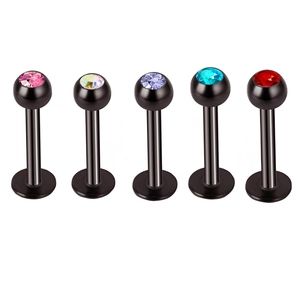 Detail view of five black stainless steel lip rings with multicolor zircon inlay set