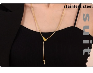 Detail of a chic gold stainless steel snake chain necklace worn on a female model