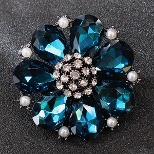 Floral brooch with deep blue crystals, pearls and sparkling white diamonds on black background