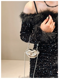 Detailed view of a silver metal lip-shaped mini clutch bag with a detachable chain strap