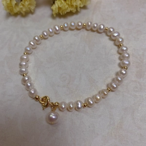 Detailed view of baroque pearls and 14K gold-filled beads with a spring ring clasp