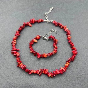 Detail view of irregular red coral stone necklace and bracelet set with silver clasps
