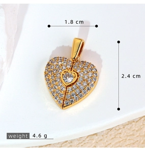 Macro shot of gold heart pendant with zircon pavé showing 1.8cm width and 2.4cm height