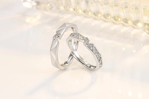 Macro shot of silver adjustable couple rings with geometric facets and micro zircon inlay