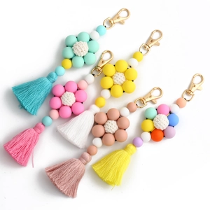Handmade silicone beaded keychain wristlet with floral motif and tassels in four colors