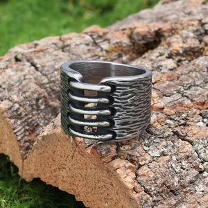 Vintage industrial style wide stainless steel ring with rustic texture on bark background
