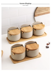 Japanese style ceramic seasoning jar set with bamboo lids and spoons on wooden trays