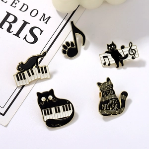 Set of five cute black cat enamel pins featuring piano keys, musical notes and cat paws