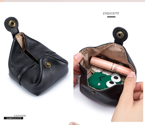 Close-up of black leather mini coin purse with snap closure showing interior capacity