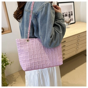 Pink quilted tote bag with golden chain strap shown on model for daily casual outfit