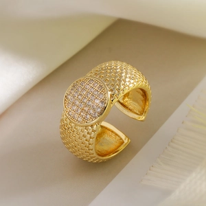 Detail of 18K gold plated heart ring featuring woven texture and micro-pave zircon stones