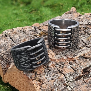 Close-up of industrial vintage steel rings with rib textures on rustic bark background