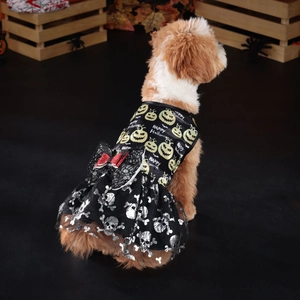 Detail of Halloween dog dress featuring pumpkin patterns and red sequin bow on black mesh