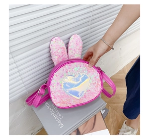 Detail of pink sequin crossbody bag for girls with cute rabbit ears and heart charm