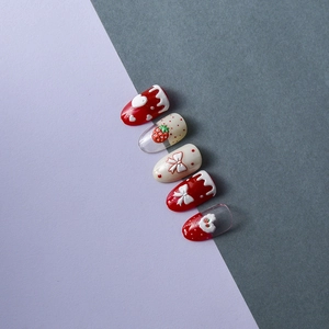 Detailed view of 5D embossed nail charms featuring red strawberries and cream bows