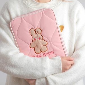 Pink quilted fabric iPad sleeve featuring an embroidered cartoon rabbit mascot