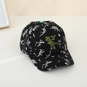Detail of black kids baseball cap with dinosaur skeleton prints and green T-Rex patch